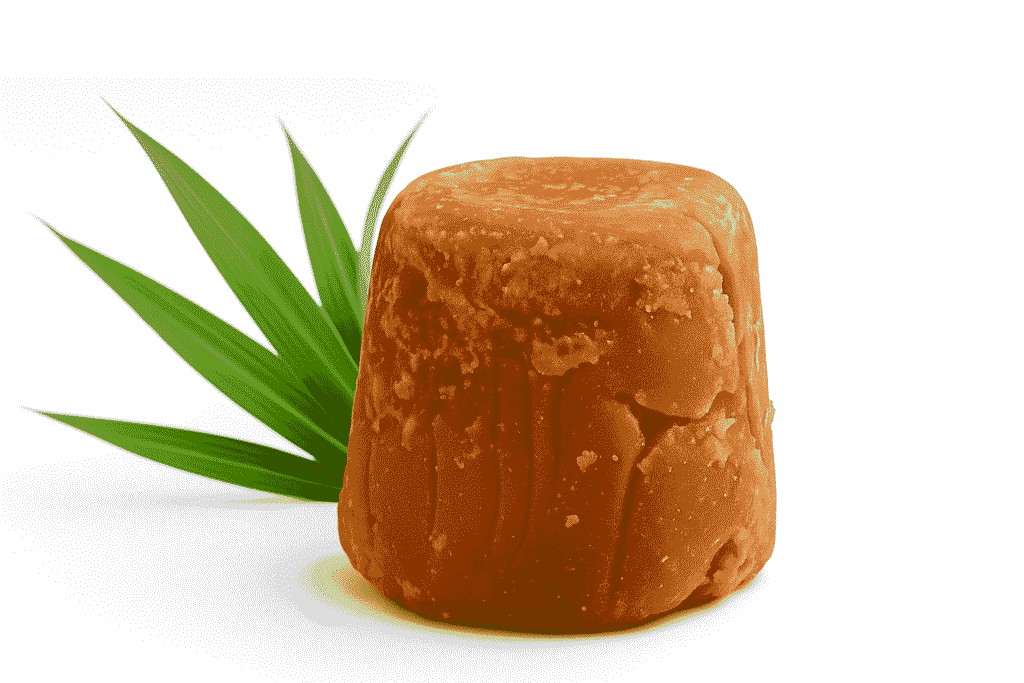 Organic jaggery blocks and powder displayed on wooden table – export quality from Al-Hyatt International